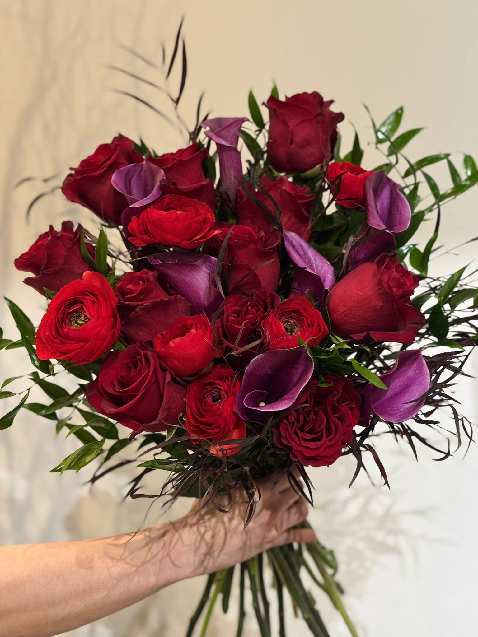 Red Freedom Roses, Purple Calla Lillies, Red Ranunculus, Agonis, and Italian Rucus Bouquet - Nationwide Shipping