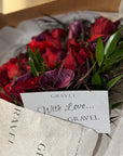 Red Freedom Roses, Purple Calla Lillies, Red Ranunculus, Agonis, and Italian Rucus Bouquet - Nationwide Shipping