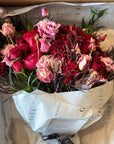 Red Roses, Lisianthus, Red Chrysanthemums, Agonis, and Italian Ruscus Hand Bouquet