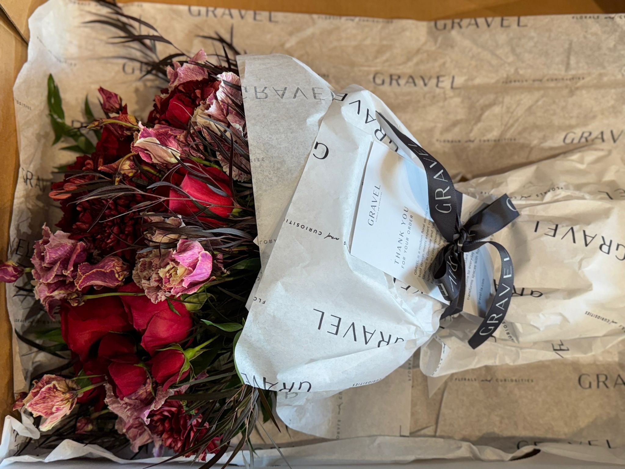 Red Roses, Lisianthus, Red Chrysanthemums, Agonis, and Italian Ruscus Hand Bouquet