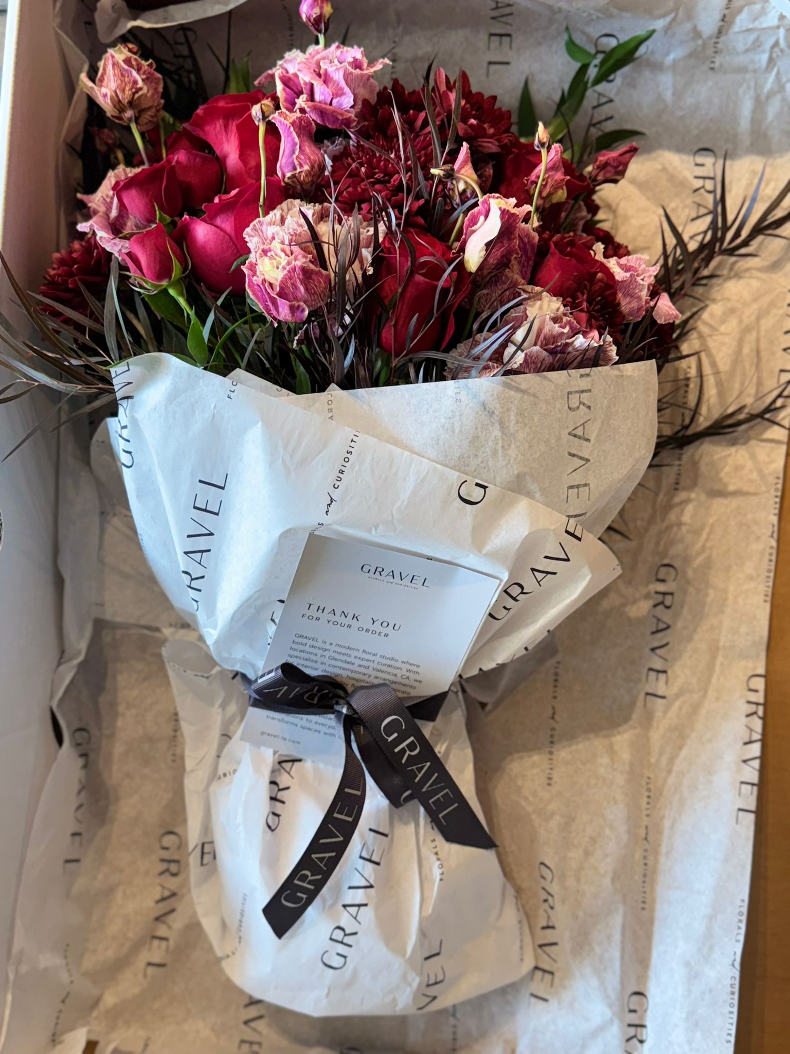 Red Roses, Lisianthus, Red Chrysanthemums, Agonis, and Italian Ruscus Hand Bouquet