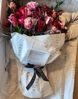 Red Roses, Lisianthus, Red Chrysanthemums, Agonis, and Italian Ruscus Hand Bouquet