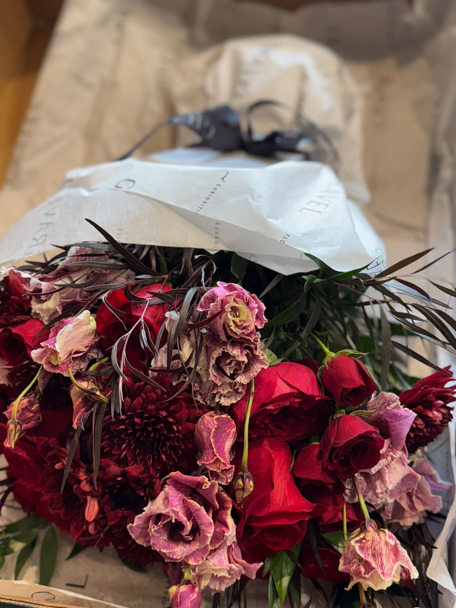 Red Roses, Lisianthus, Red Chrysanthemums, Agonis, and Italian Ruscus Hand Bouquet