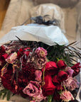 Red Roses, Lisianthus, Red Chrysanthemums, Agonis, and Italian Ruscus Hand Bouquet