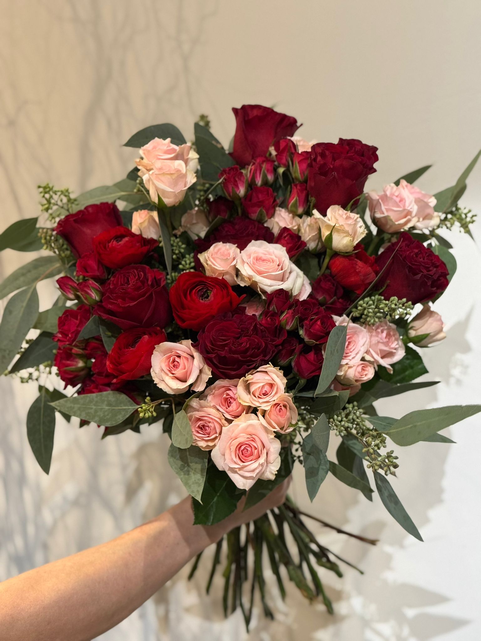 Red and Pink Roses, Ranunculus, and Eucalyptus Bouquet 