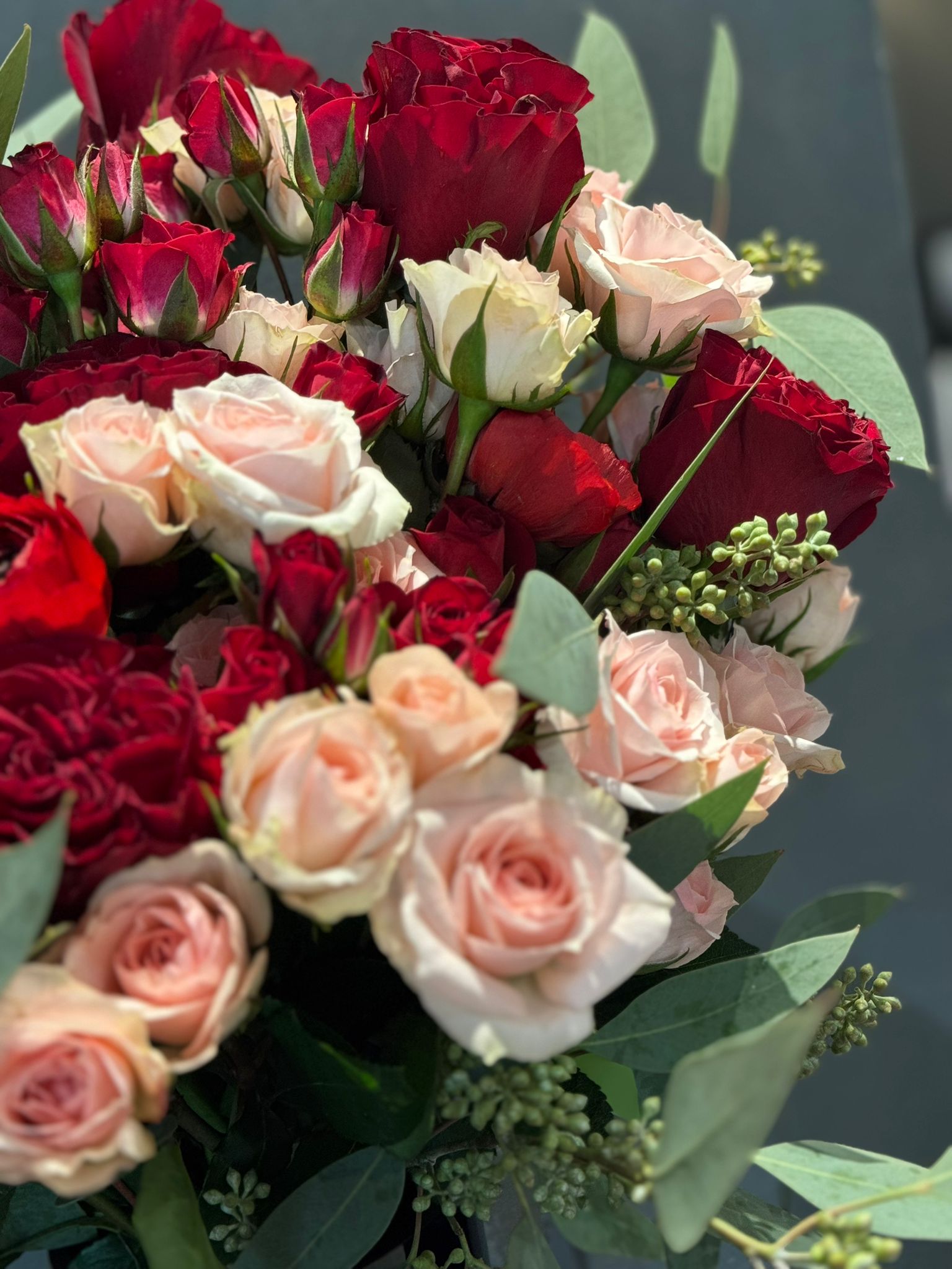 Red and Pink Roses, Ranunculus, and Eucalyptus Bouquet 