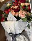 Red and Pink Roses, Ranunculus, and Eucalyptus Bouquet 