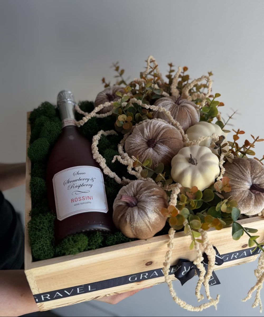 Bottle of Rossetti champagne in a decorative box with pumpkins and greenery