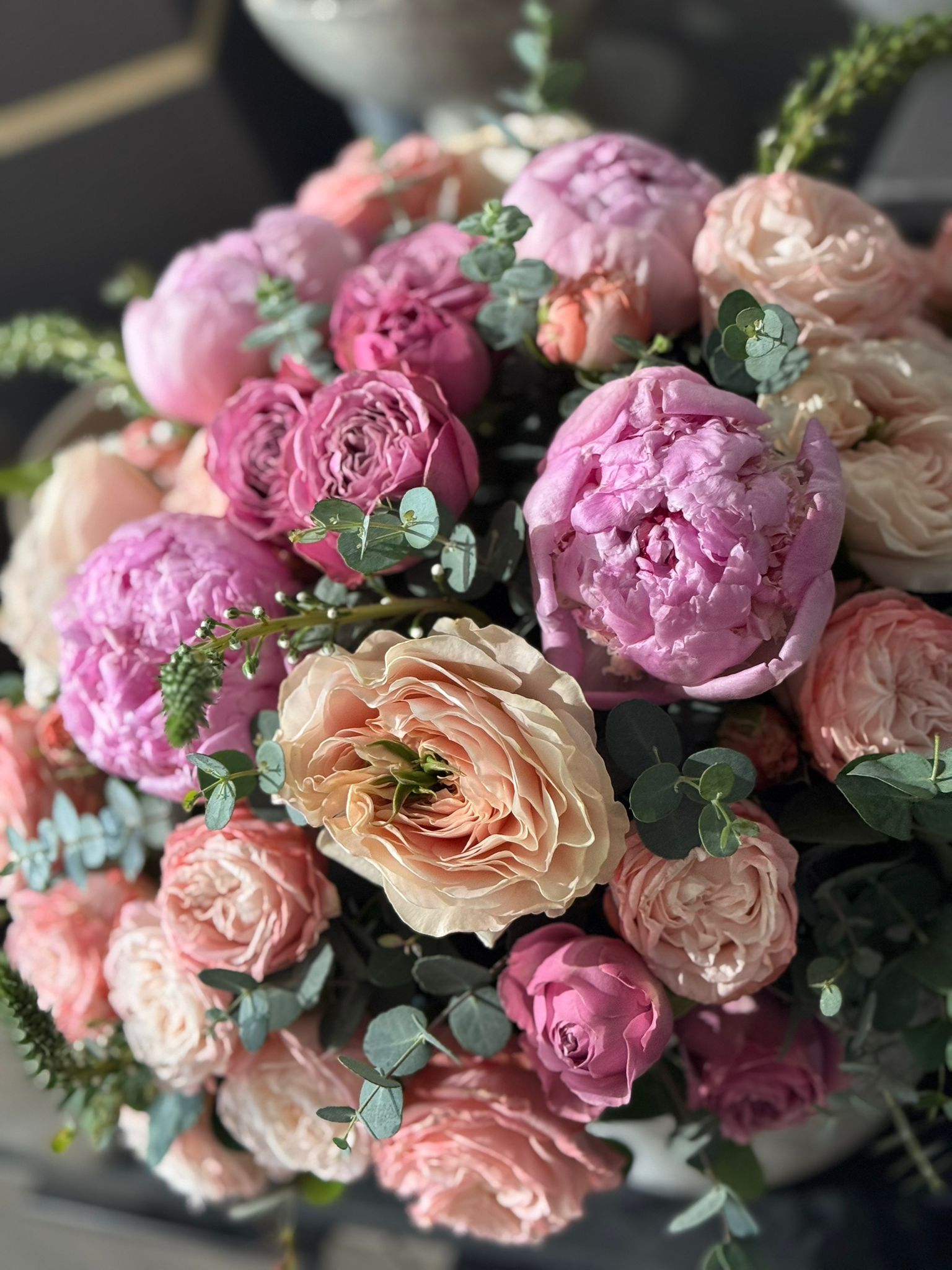 Pink Peonies, Pink Garden Roses, Pink Spray Roses, and Eucalyptus Spiral Floral Arrangement Closeup