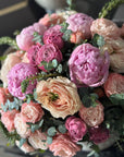 Pink Peonies, Pink Garden Roses, Pink Spray Roses, and Eucalyptus Spiral Floral Arrangement Closeup